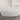 Curved armrest design of white bouclé sofa captured from above