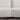 Seam and leg detail between two joined sections of white bouclé sofa