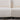 Seam and leg detail between two joined sections of white bouclé sofa