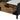 Detail of wooden storage drawer with smooth gliding track extended from coffee table base.