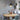 Farmhouse pendant light hanging above round light wood dining table