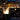 Fire column with tall flame on city street at night