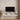 Floating TV stand with cabinet doors open showing internal compartments and cable holes.