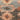 Close-up of a textured fabric with floral patterns in earthy tones.