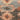 Close-up of a textured fabric with floral patterns in earthy tones.
