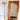 Free-form mirror with rounded asymmetrical frame and stacked books in cozy interior