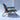 Side profile of mid-century inspired blue armchair with wood frame and metal legs