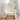 Front-facing beige glider chair placed in a bright reading nook