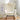 Front-facing beige glider chair placed in a bright reading nook