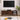 Full front view of the walnut TV stand in a styled room setting, flanked by plants and modern decor