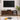 Full front view of the walnut TV stand in a styled room setting, flanked by plants and modern decor