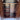Arched cabinet interior layout with symmetrical compartments and rich wooden finishes.