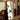Full-length mirror with cherry wood frame reflecting indoor plant