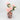 Glass vase in pink with black patterns holding pastel peony stems