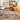 Jute area rug styled in a bright bohemian living room with pillows and artwork