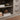 Lower cabinet shelf styled with rustic decor and faux drawer detailing on farmhouse TV stand.