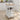 White kitchen cart with a wooden top in a bright kitchen setting
