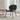 Modern black leather lounge chair in bright living room with wood floors