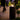 Modern fire column with glowing flame on cobblestone street