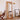 Organic shape full body mirror in natural pine frame beside floor lamp and newspaper art