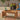Outdoor acacia coffee table with drinks and fruit tray on floral patio rug