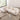 Overhead angle of curved white bouclé sectional sofa with throw blanket