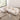 Overhead angle of curved white bouclé sectional sofa with throw blanket