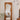 Pine wood framed mirror with fluid edge design and wall-mounted reading lamp