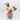 Pink marbled glass vase with artificial peony bouquet angled view