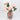 Pink marbled glass vase with artificial peony bouquet angled view