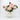 Pink peony arrangement in textured white ceramic vase