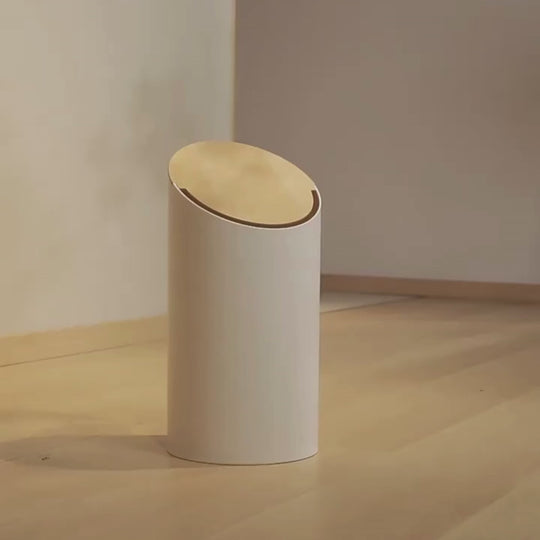 Minimalist white and black swing trash bins with wooden lid for Japandi-inspired interiors.