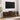 Rattan TV stand styled in a living room setup beneath a mounted TV, accessorized with a speaker and small decor