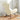 Rear angle of beige teddy rocking chair on orange checkerboard rug