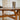 a round dining table for 4, showing the intricate wood carvings