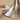 the tulip metal base of a wood dining table