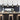 row of four matte black cage pendant lights above kitchen island