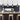 row of four matte black cage pendant lights above kitchen island