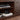 Shelving with media players and headphone storage on espresso TV stand.