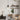 single matte black pendant light above wooden desk in cozy home office