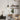 single matte black pendant light above wooden desk in cozy home office