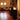 Tall black fire column adding warmth to modern restaurant interior