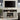 Tall farmhouse TV stand placed below a wall-mounted TV, styled with flowers and candles.
