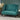 Teal fabric loveseat in modern room with pampas grass and round brass table