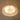 Textured acrylic flush mount ceiling light glowing on beige ceiling