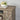 Top corner of farmhouse TV stand styled with books and floral centerpiece.