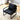 Top-down view of black leather accent chair in minimalist room