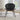 Tripod shell chair with wide black seat and sleek metal frame
