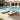 Two Charmydecor teak finish acacia wood chaise lounges with cream cushions in a poolside patio setting