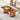 Walnut wood coffee table with rattan panel legs in cozy living room setting